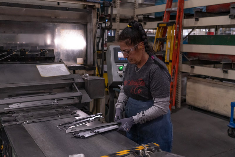 Lozier employee stacking products in the plant