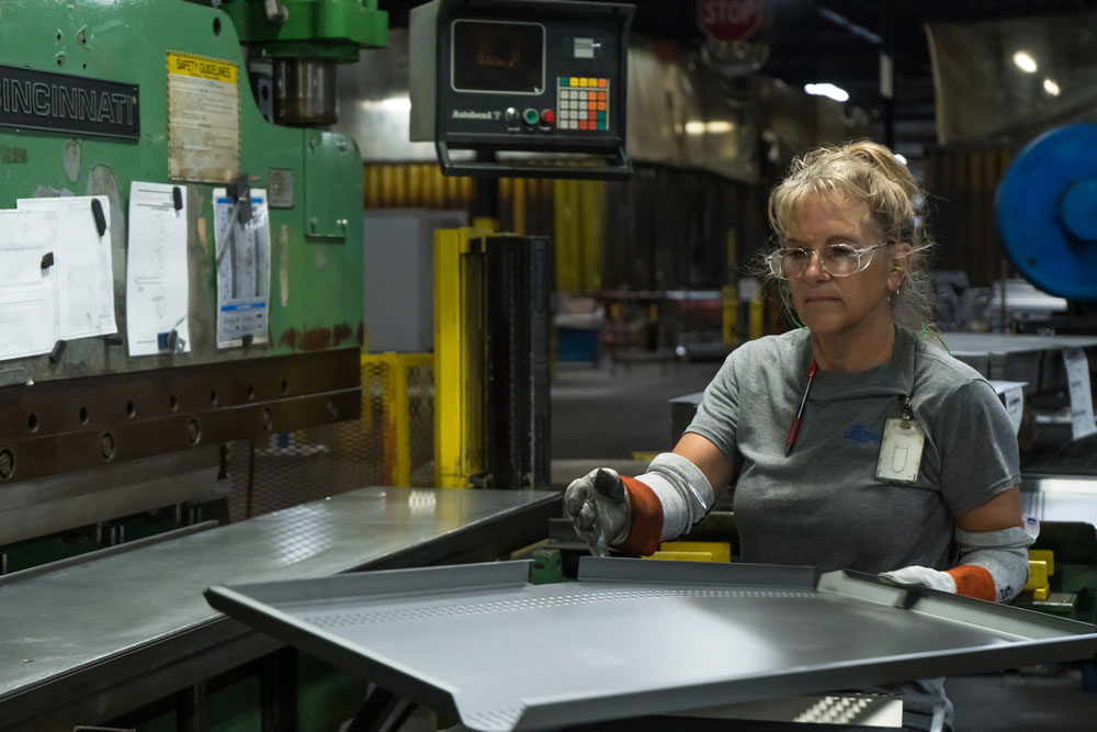 Lozier employee working in manufacturing plant.