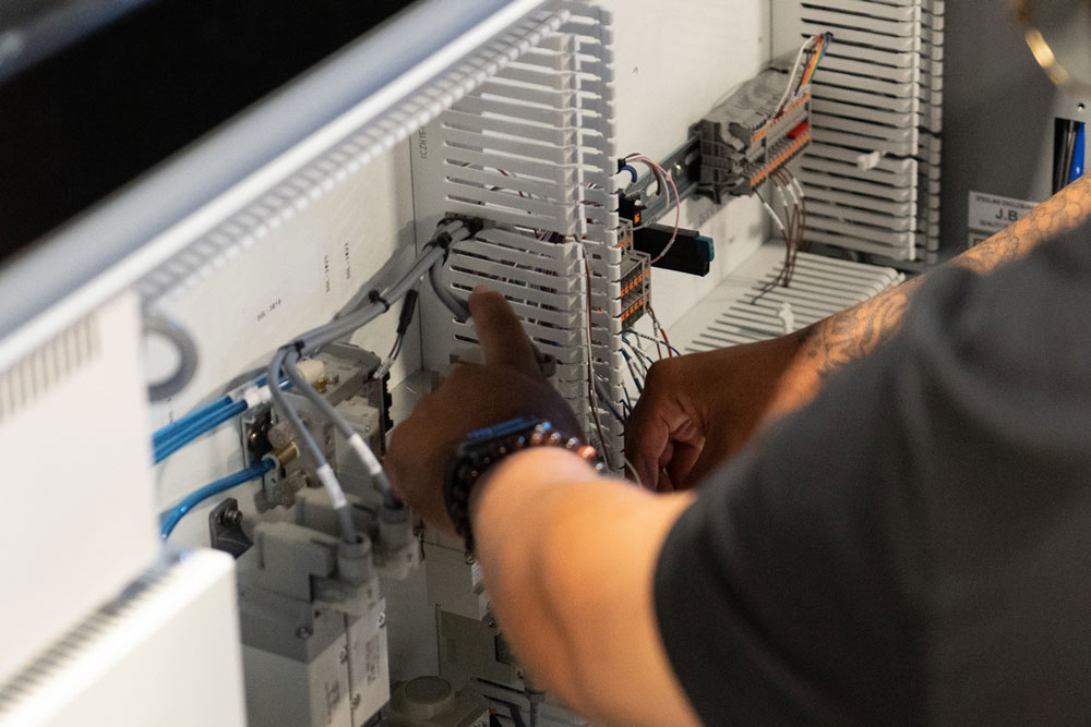 Casi technician working on a machine